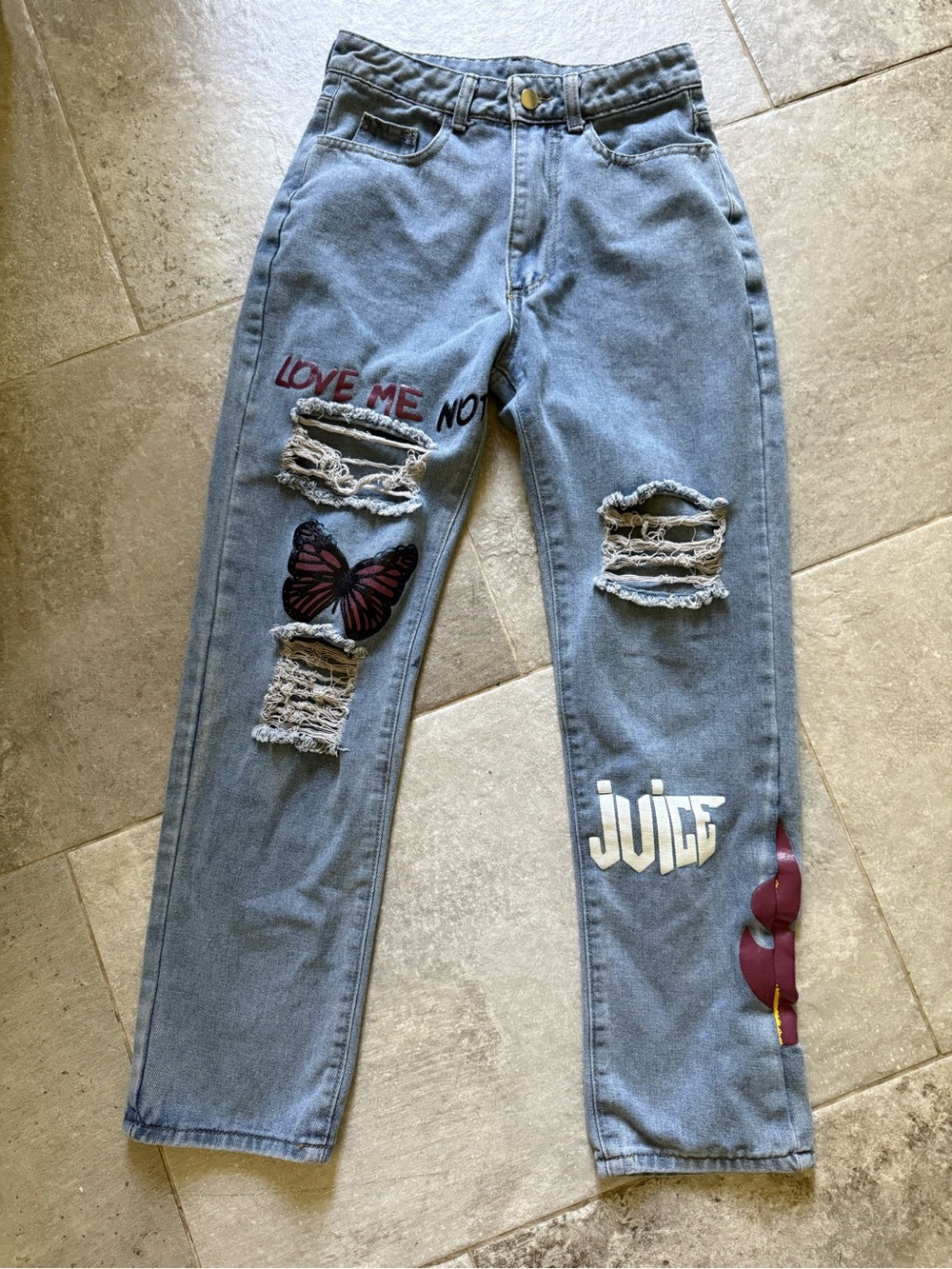 Light Blue Straight-Leg Jeans with Distressed Details and Graphic Accents